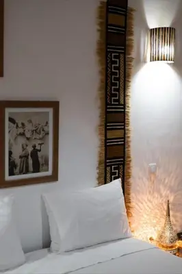 a bedroom with a bed with a lamp and a picture at Luxury VILLA - Pool-view Atlas-Ourika-Golfs in Akkara