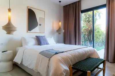 a bedroom with a large bed and a window at Maison soli Marrakech