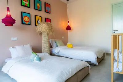 two beds in a room with a palm tree at Maison soli Marrakech