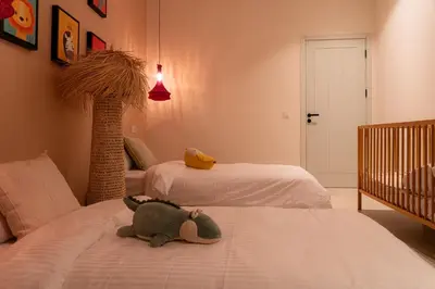 a bedroom with two beds and a stuffed animal on the bed at Maison soli Marrakech