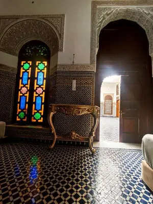 a room with a bench and a stained glass window at Riad Benkirane in Fès
