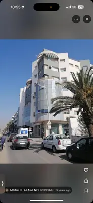 a large building with cars parked in front of it at basim swedin in Oulad Akkou