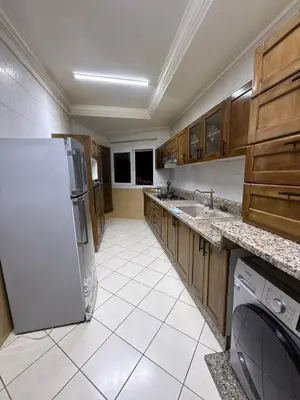 a kitchen with a refrigerator and a sink at basim swedin in Oulad Akkou