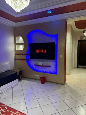 a living room with a television on a wall at basim swedin in Oulad Akkou