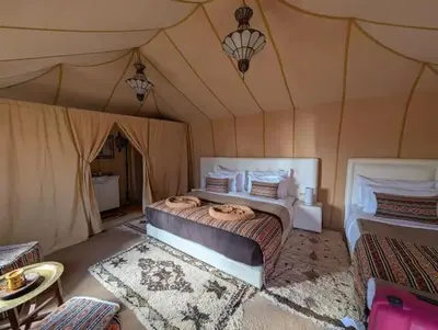 a bedroom with a bed in a tent at Mirage Luxury Camp in Merzouga
