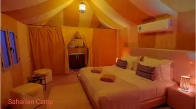 a bedroom with a large bed in a room at Mirage Luxury Camp in Merzouga