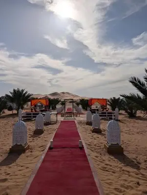 a red carpet in the sand on a beach at Mirage Luxury Camp in Merzouga