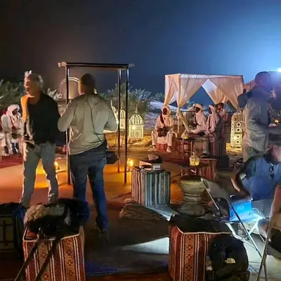 a group of people on a stage at night at Mirage Luxury Camp in Merzouga