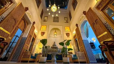 a large room with a table and a chandelier at Dar Magic Fes in Fès