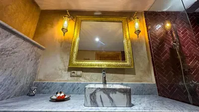 a bathroom with a sink and a mirror at Dar Magic Fes in Fès