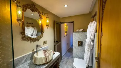 a bathroom with a sink and a mirror at Dar Magic Fes in Fès