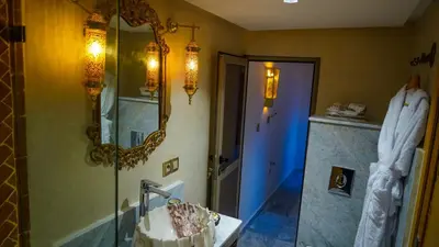a bathroom with a sink and a mirror at Dar Magic Fes in Fès