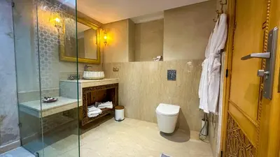 a bathroom with a toilet and a glass shower at Dar Magic Fes in Fès