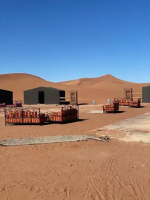 a desert with a tent in the sand at Tarrast Desert Camp in Mhamid