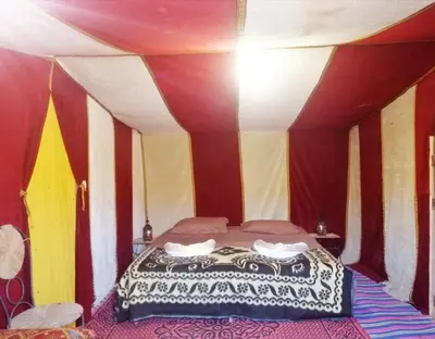 a bedroom with a bed in a tent at Tarrast Desert Camp in Mhamid