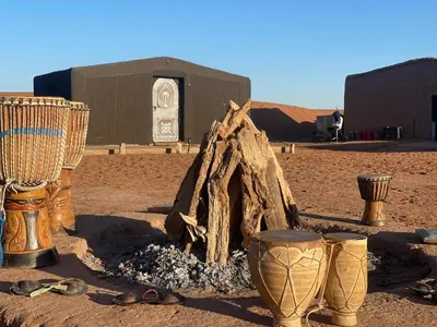 a group of boots and other items in the desert at Tarrast Desert Camp in Mhamid