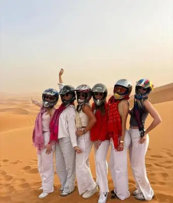 a group of women standing in the desert at Africa Berber Camp in Merzouga