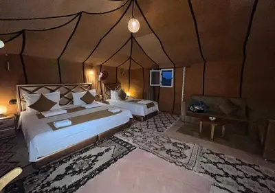 a bedroom with two beds in a tent at Solaris Luxury Camp in Merzouga