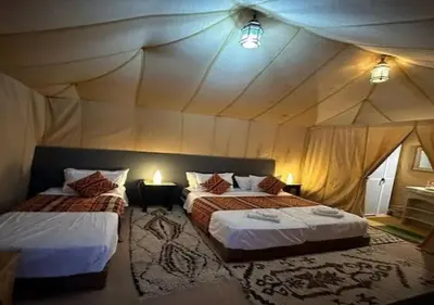 a bedroom with two beds in a tent at Solaris Luxury Camp in Merzouga