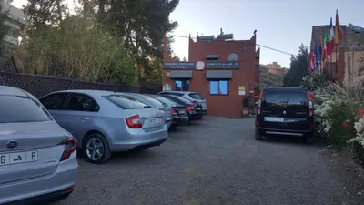 a row of cars parked in a parking lot at Hôtel Ajil Cascades D'ouzoud in Ouzoud