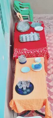 a table with plates and wine glasses on it at Oasis travel in Ksar Tazouga