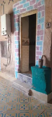 an entrance to a building with a brick wall at Oasis travel in Ksar Tazouga