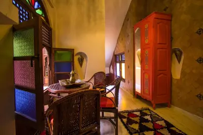 a room with a table and chairs and a window at Riad Dar Mansoura in Fès