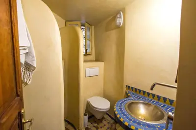 a small bathroom with a toilet and a sink at Riad Dar Bab Guissa in Fès