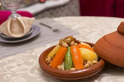 a bowl of vegetables with nuts on a table at Riad Dar Bab Guissa in Fès