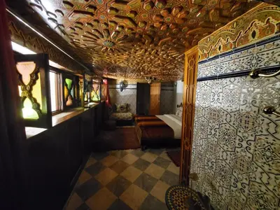 a room with a bathroom with a tub and a room with at Riad Royal in Meknès