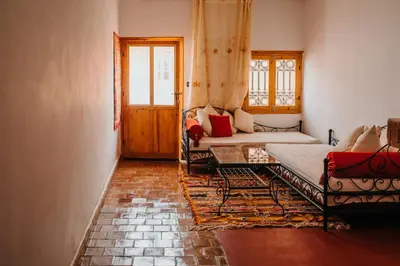 a living room with two beds and a couch at Kasbah Petit Nomade in Tinerhir