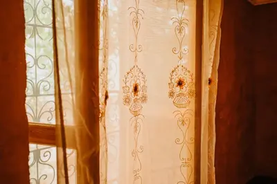 a curtain on a window in a room at Kasbah Petit Nomade in Tinerhir