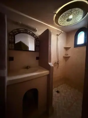a bathroom with a sink and a mirror at Riad Amar in Merzouga