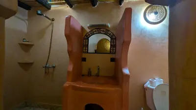 a bathroom with a shower and a toilet with a sink at Riad Amar in Merzouga