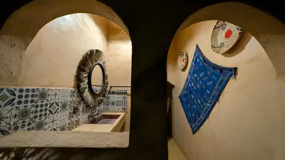 a bathroom with a sink and a mirror at Riad Amar in Merzouga