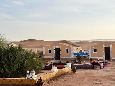 a house in the middle of the desert at Desert Tours & Camp Chraika in Mhamid