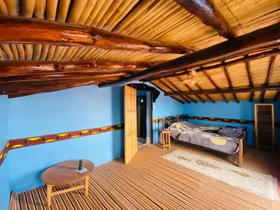 a bedroom with a bed and a wooden ceiling at Desert Tours & Camp Chraika in Mhamid