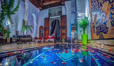 a large swimming pool in a large room at Riad Almaz in Fès