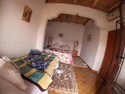 a living room with two couches in a room at Citadelle Gorges in Ait Ben Ali