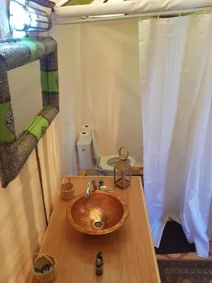 a bathroom with a wooden sink and a toilet at Dune Merzouga Camp in Merzouga