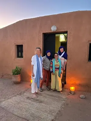 a group of people standing outside of a building at Sahara Peace in Mhamid