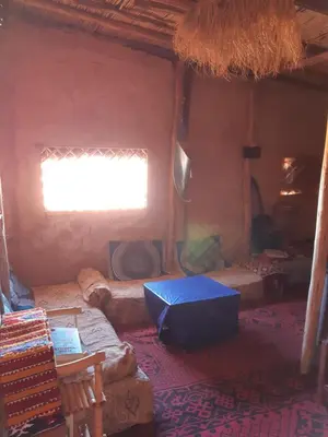 a room with a window and a couch in a house at Sahara Peace in Mhamid
