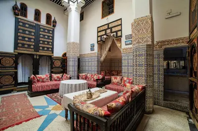 a room with couches and a table in a building at Dar Hlimi in Fès