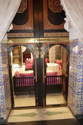 a room with a door with two beds in it at Dar Hlimi in Fès