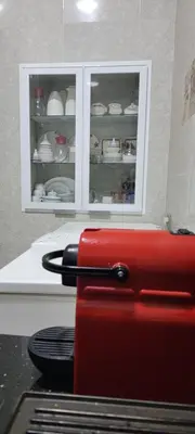 a red suitcase sitting on top of a stove in a kitchen at Dar Hlimi in Fès