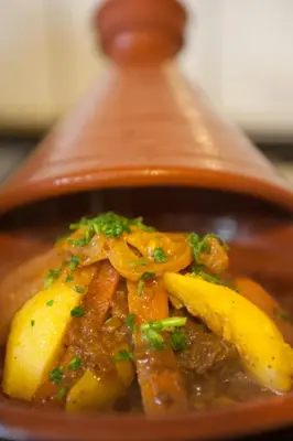 a bowl of stew with carrots and other vegetables at Dar tiwira in Aït Baha