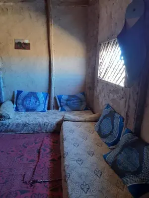 a small room with a bed and a window at Sahara Peace camp in Zagora