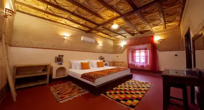 a bedroom with a large bed in a room at Ecolodge l'île de Ouarzazate in Ouarzazate