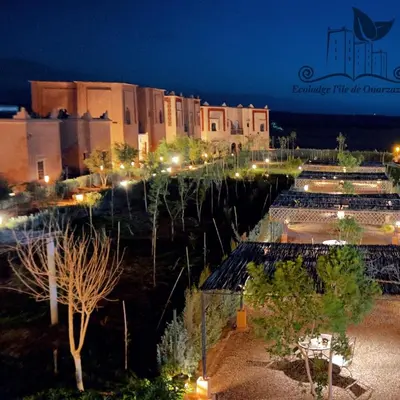a view of a city at night with lights at Ecolodge l'île de Ouarzazate in Ouarzazate