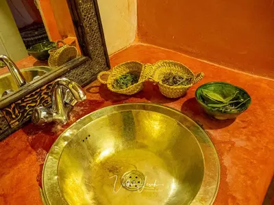 a silver sink in a bathroom with a mirror at Riad Tabhirte in Agdz